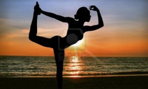 6359116-practicing-yoga-at-sunrise-on-the-beach